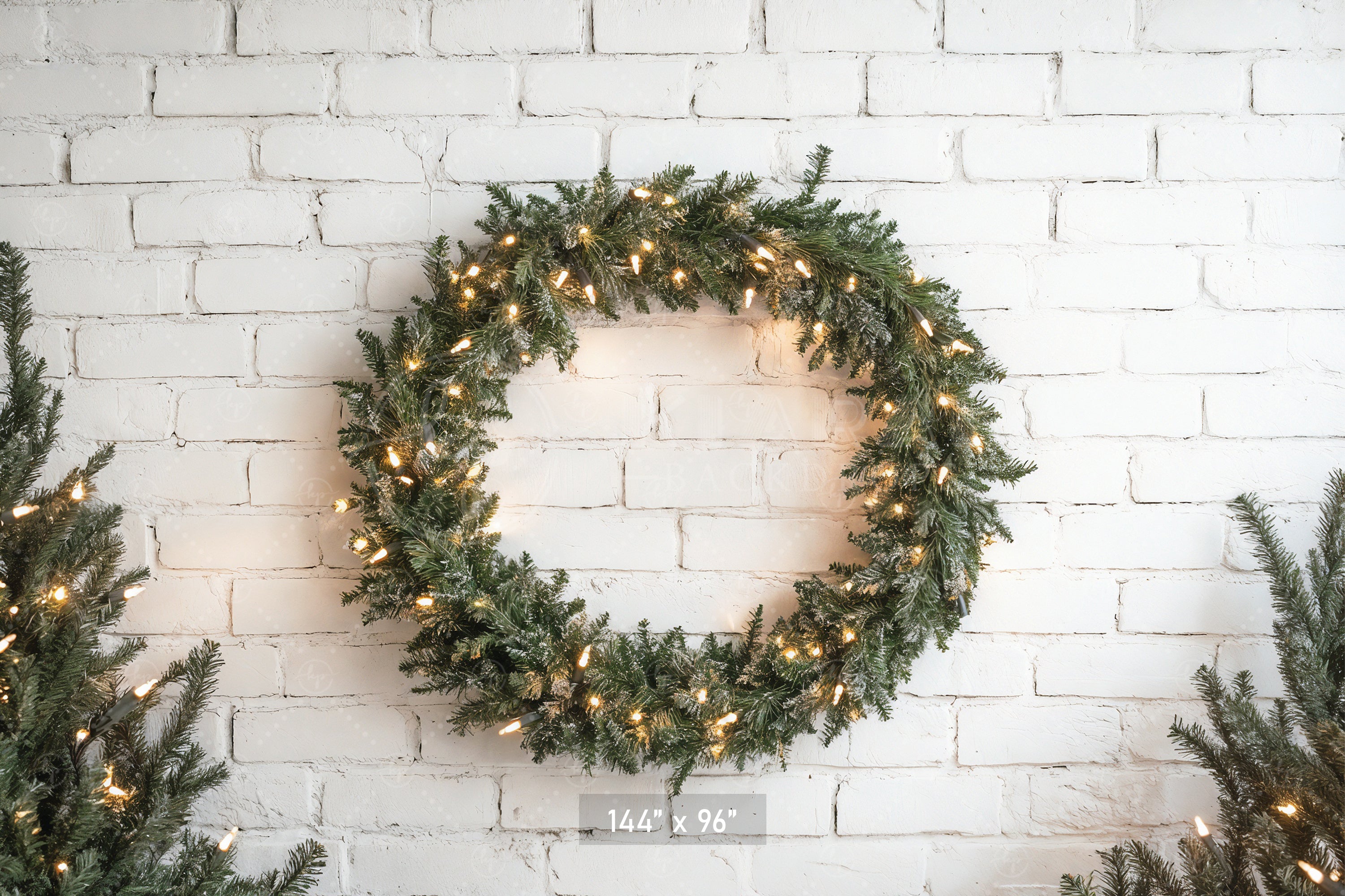 Lighted Wreath on White Brick Backdrop