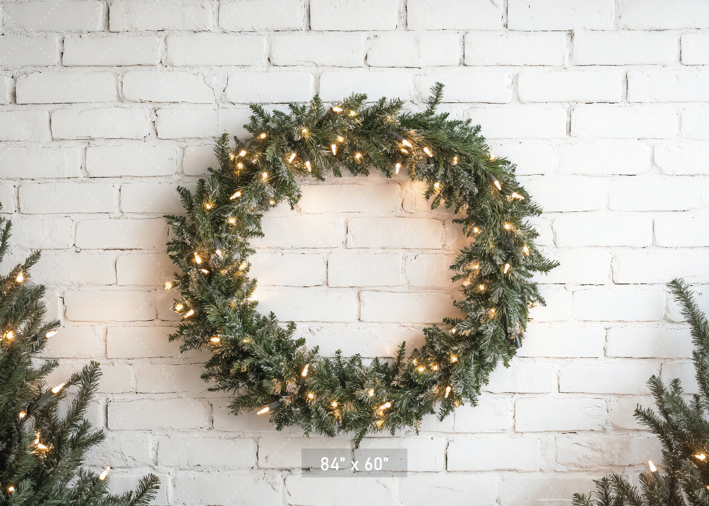 Lighted Wreath on White Brick Backdrop