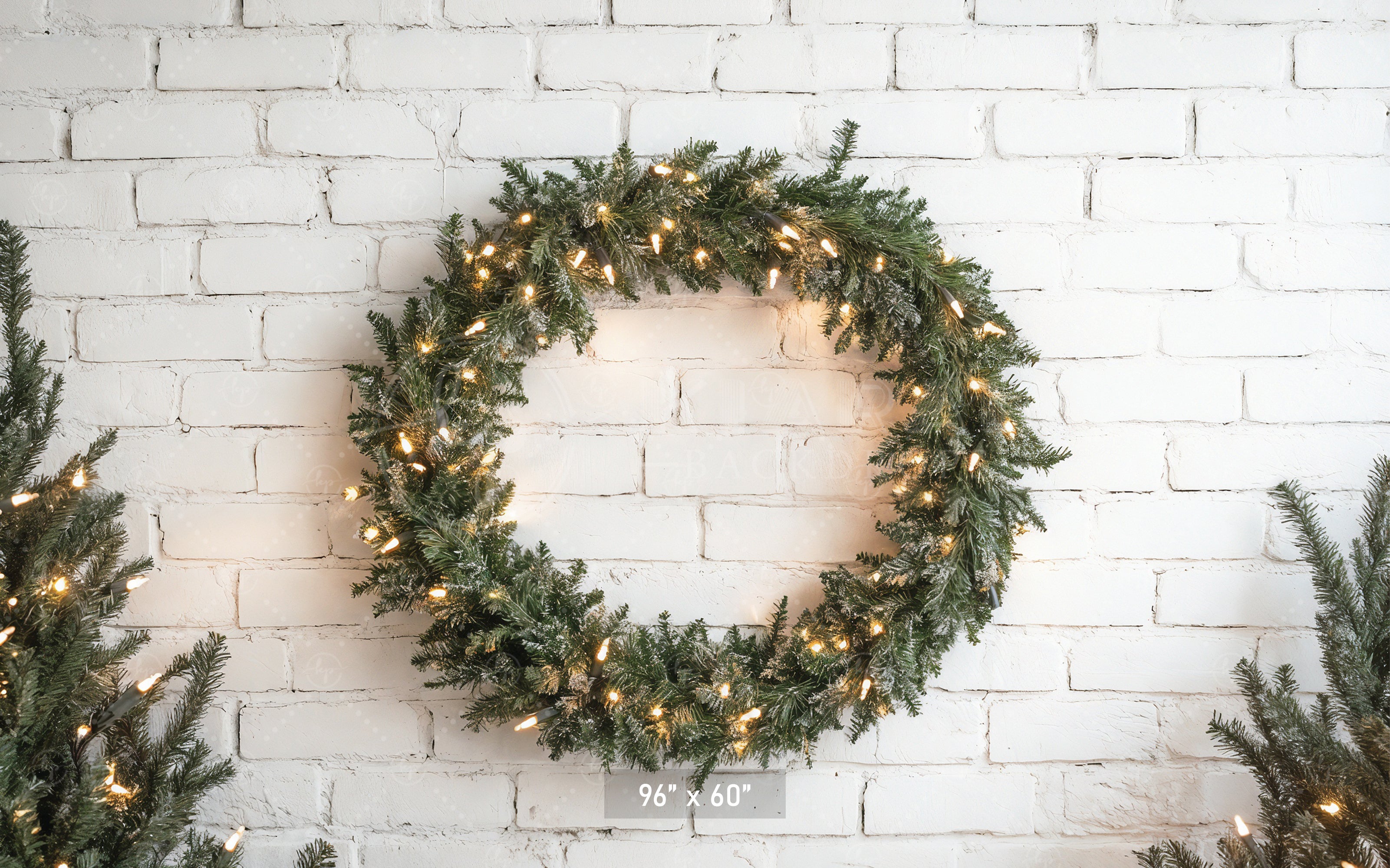 Lighted Wreath on White Brick Backdrop